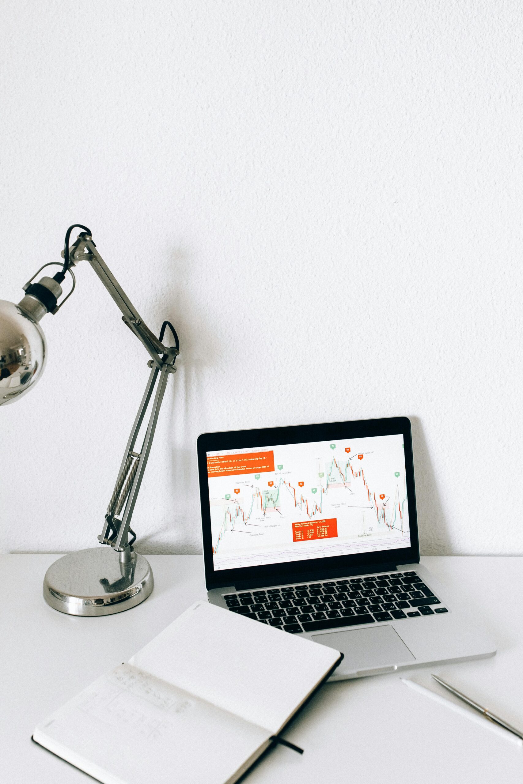 A sleek workspace featuring a laptop displaying data analysis charts, perfect for business and technology themes.
